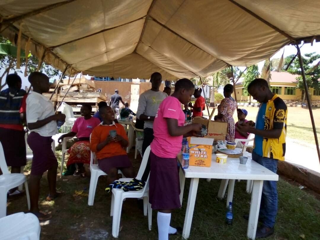 Community members gathered under a tent for a support forum