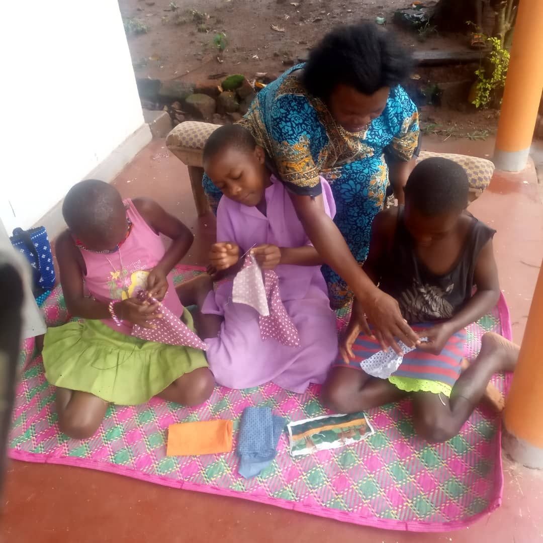 A mentor working with girls during a skills session